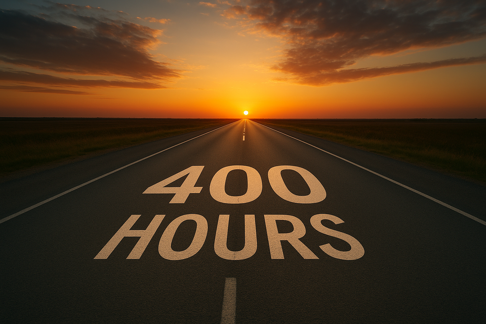 400 hours written on a road stretching towards a sunset